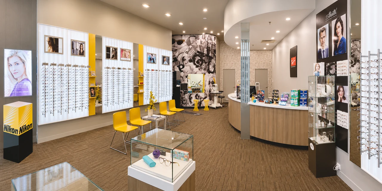 Frame displays, yellow waiting chairs and the service counter in our Cannington practice